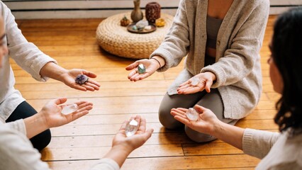 Three people holding crystals in hands