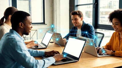 Four people working together on laptops