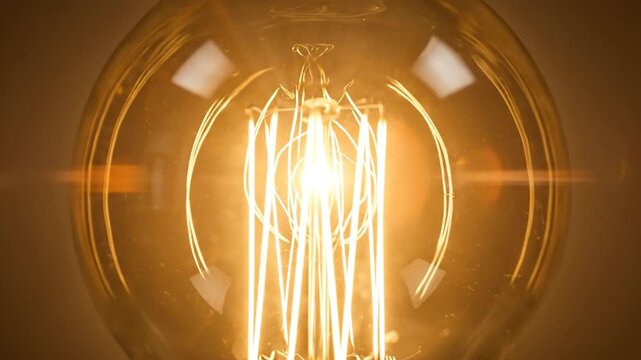 Close-up of a vintage-style light bulb with glowing filament, creating a warm and inviting atmosphere.
