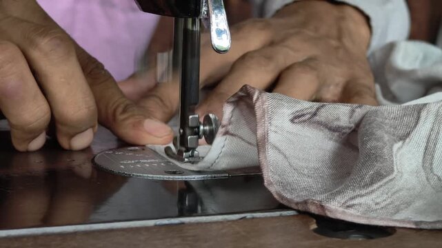 the hand sewing the textile neatly