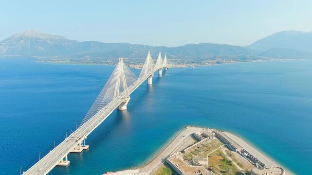 Patras, Greece. Rio Fortress. The Rio-Antirrio Bridge. Officially the Charilaos Trikoupis Bridge. Bridge over the Gulf of Corinth (Strait of Rion and Andirion). Drone footage, Departure of the camera