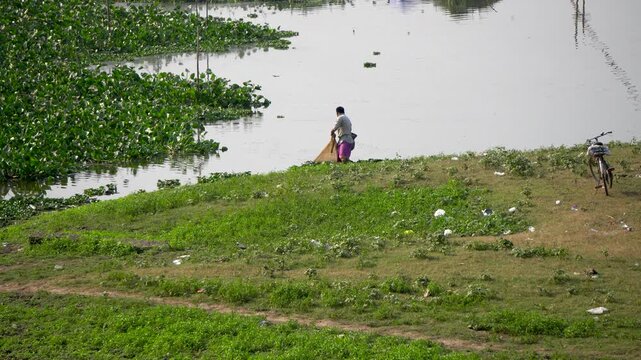 Shot of a fisherman catching fish with a fishing net at Deepor Beel Guwahati Assam Close-Up 3