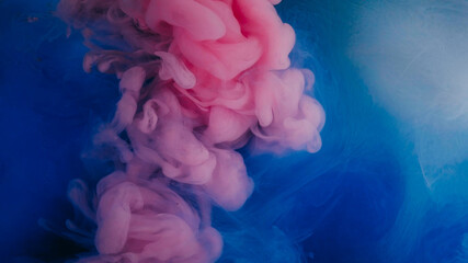 Color smoke. Paint water splash. Defocused pink purple blue fluid chemical wet fume spreading on abstract art acrylic creative background.