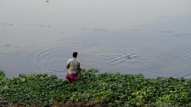 Shot of a fisherman catching fish with a fishing net at Deepor Beel Guwahati Assam Close-Up 1