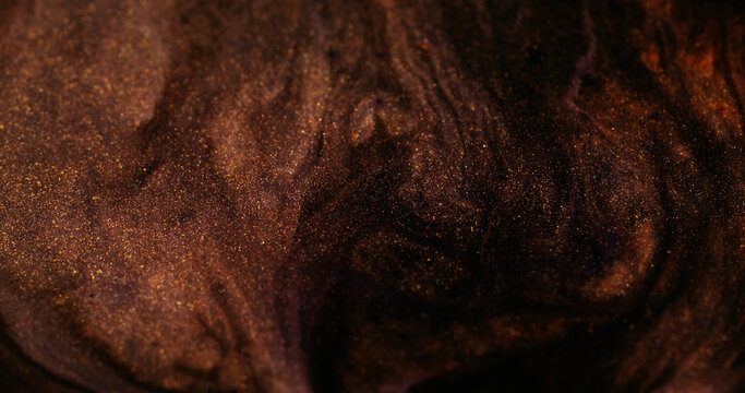 Blur pigment blend. Paint flow. Dark black wave dissolving on sparkling brown lava. Abstract color particles texture curl background.