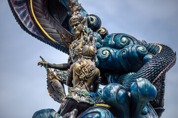 Fototapeta premium The backdrop of sculptures and artworks at tourist attractions, such as snakes, nagas, Buddha statues, and models, reflects the antiquity and stories of the place, making it captivating.