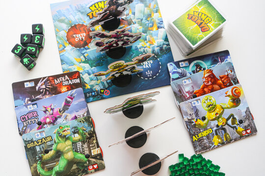 Tangerang, Indonesia - June 30, 2025: A high-angle view of the popular monster-themed board game "King of Tokyo".  The image showcases various monster standees, power cards, and dice.