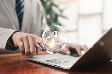 Businessman using laptop with cloud upload and download interface, representing secure cloud computing, data storage, file management, digital workspace, online backup, and enterprise technology.