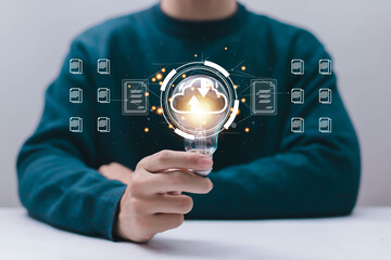 Person holding light bulb with cloud computing upload and download interface and document icons, representing digital innovation, cloud data storage, smart technology, online file management, future.