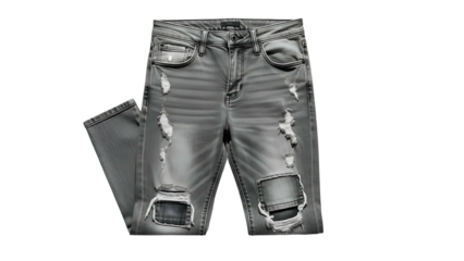 Torn, grey denim jeans laid flat, revealing rips and patches. High contrast lighting