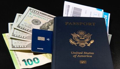 Naklejka premium US passport with boarding pass. Cash credit card for travel. Travel passport and money for trip. Airport check passport in concept. American passport and airline tickets. Vacation and travel theme.