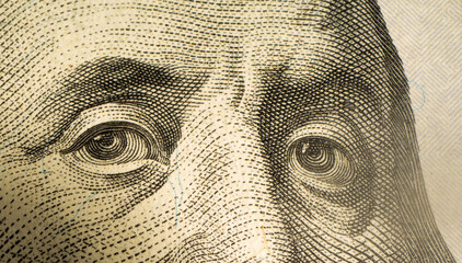 Macro close up of George Washington eyes on US dollar banknote. Money dollar detail. Portrait texture on 100 dollars.