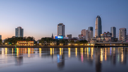 Naklejka premium Twilight Cityscape of Ningbo with Reflections on Water