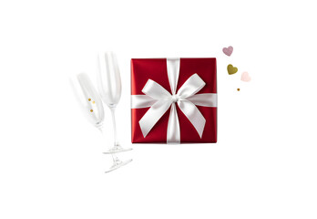 Valentine's Day gift box along with champagne glasses. Set against a white background.