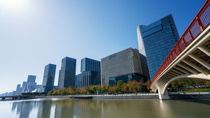 Fototapeta premium Modern Cityscape with Skyscrapers and River Bridge