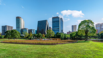 Fototapeta premium Urban Park with Modern Skyscrapers in Clear Sky