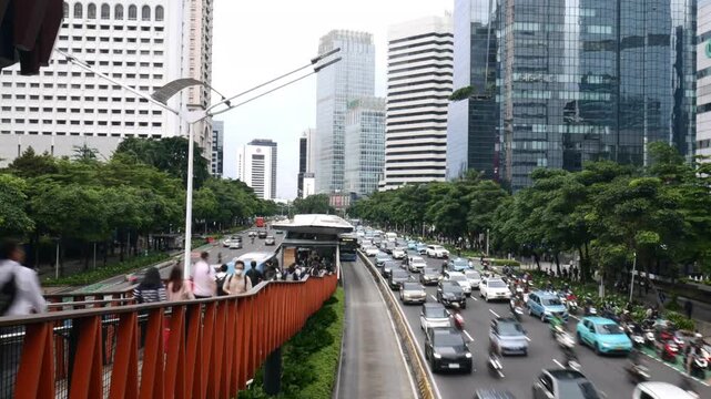 Timelapse of Busy Traffic Light Trails and City Lights at Sudirman Business District
