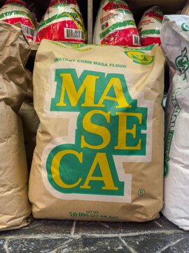 Calgary, Alberta, Canada. Jan 19, 2026. A large 50-pound bag of Maseca brand instant corn masa flour on a store shelf with corn husks above.