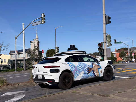 Waymo autonomous Jaguar I-PACE robotaxi with custom illustrated wrap by artist Nicole Poppell - San Francisco, California, USA - January 18, 2026