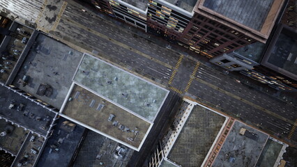 A dynamic aerial perspective shows a busy downtown area. Skyscrapers meet wide roads, showcasing vehicles navigating the streets beneath a clear urban sky.
