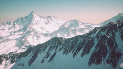 Obraz premium Golden light begins to touch the snowy peaks of majestic mountains. The calm scene showcases rocky formations and snow covered slopes in a tranquil dawn setting.