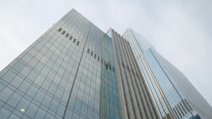 Tall glass office buildings viewed from ground level perspective