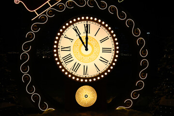 Vintage clock with Roman numerals showing midnight time close-up