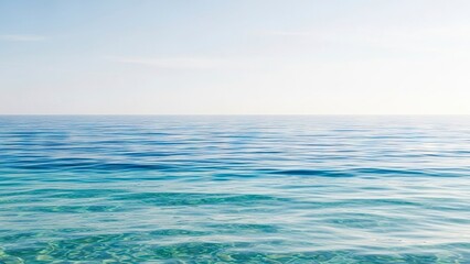 Obraz premium Calm blue sea with visible seabed under clear skies reflecting light