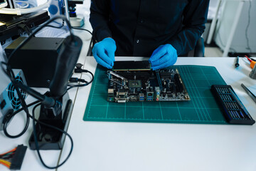 Hands repairing electronic devices. Electronic technician.