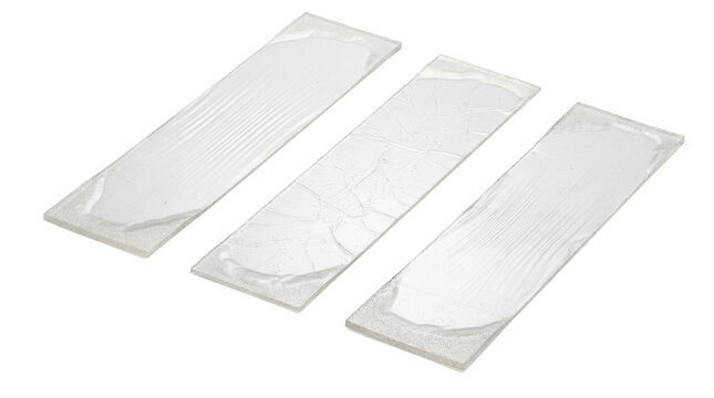 Three clear glass microscope slides on white background