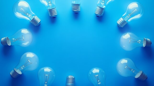 68.A visually striking image of several CFL light bulbs arranged in a circular formation on a bright blue background. The light bulbs are illuminated, with their soft glow representing the theme of - Powered by Adobe