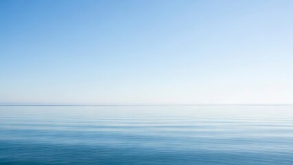 Fototapeta premium Serene scene with a calm blue ocean merging into a light blue sky