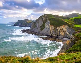 Dramatic coastal cliffs under a cloudy sky. Waves crash on the shore