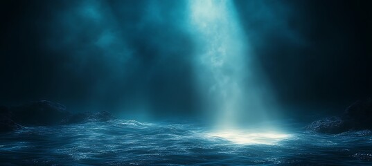 Naklejka premium Dramatic beam of light shines down on dark ocean waves and rocky shore spotlight