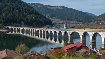 Scenic Arched Viaduct Crossing Lake Izvorul Muntelui In Romanian Mountains