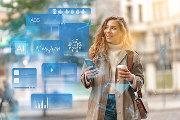 Woman holds coffee and phone while looking at digital data on the street in a city