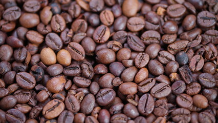 Fototapeta premium Coffee beans closeup, Detailed view of varied roasted coffee beans, Intimate photograph emphasizing diverse roasted coffee beans with textured surfaces and rich coloring