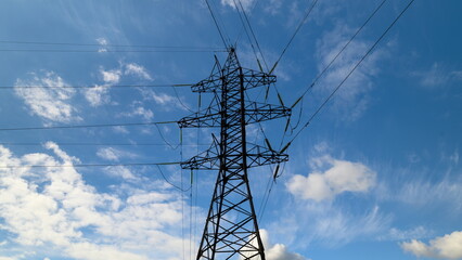 An Electric Power Transmission Tower Standing Tall Against a Dramatically Cloudy Sky