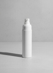 Minimalist White Spray Bottle on Light Gray Surface with Soft Shadow &ndash; Studio Shot