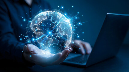 Person holds a bright blue digital earth globe with global network connections and a lapto