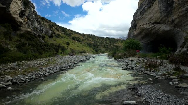 Mountain River Flowing Through Rocky Gorge Under Dramatic Sky