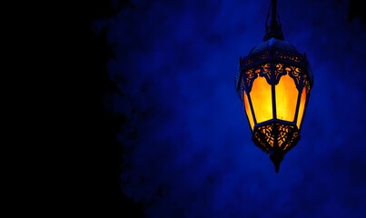 Obraz premium Dramatic night scene with large ornate metal lantern glowing warm gold inside