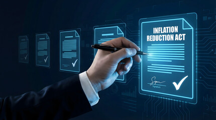 Businessman hand signing Inflation Reduction Act digital document on futuristic screen