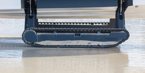 Naklejka premium A boat on tracks moves along the beach