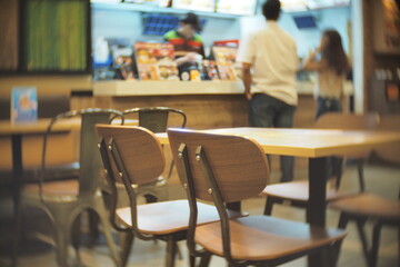 A Blurred Fast Food Restaurant Interior With Chairs