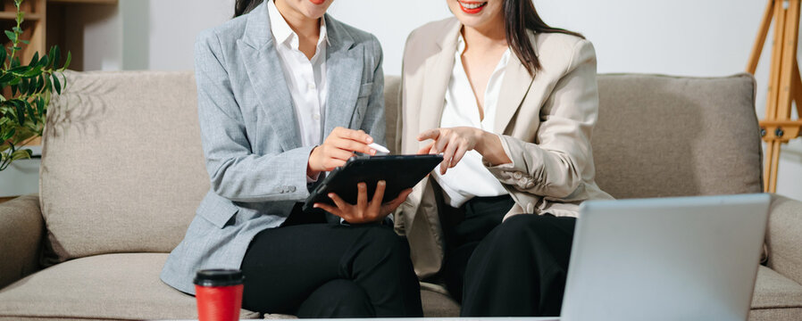 Asian businesswomen working together using tablet and laptop, discussing strategy and planning. Teamwork, consulting, female leadership, startup