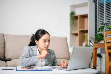 Stressed Asian businesswoman working alone at home office. Burnout, work stress, financial problem, fatigue and pressure from business deadline