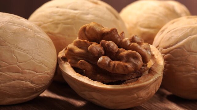 Walnuts slowly turning. Close-up, macro. One no-shell walnut.