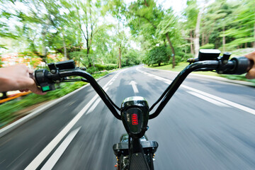 Riding on high speed electric bicycle in park