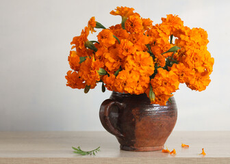 Marigolds blooming in rustic clay pot